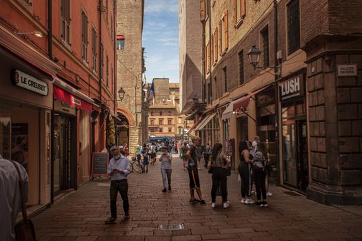 BOLOGNA, ITALY 17 JUNE 2020: Alley of the city of Bologna in Italy with people walking