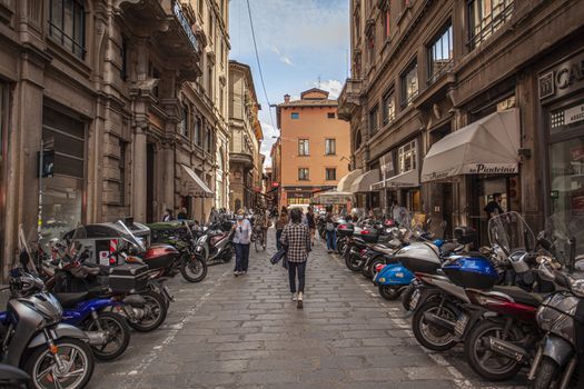 BOLOGNA, ITALY 17 JUNE 2020: Alley of the city of Bologna in Italy with people walking