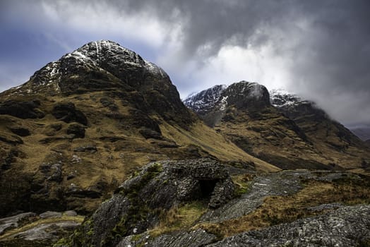 Glencoe, Scotland - Jan 2020: Bothy shelter at the base of the 3 sisters as a winter storm passes overhead