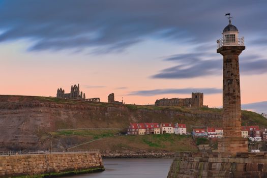 Whitby, Uk - Mar 2020: Golden Hour skies over Whitby Abbey and the pier at Whitby Bay