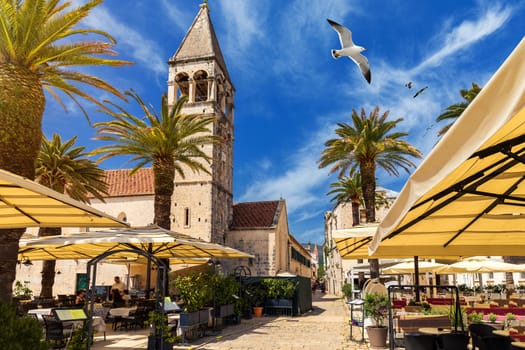 View at town Trogir, old touristic place in Croatia Europe with seagull's flying over city. Trogir town coastal view. Magnificent Trogir, Croatia. Sunny old Venetian town, Dalmatian Coast in Croatia.