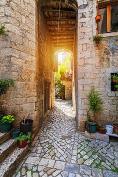 Narrow street in historic town Trogir, Croatia. Travel destination. Narrow old street in Trogir city, Croatia. The alleys of the old town of Trogir are very picturesque and full of charm. Croatia.