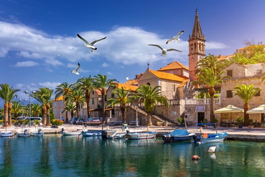 Splitska village with beautiful port and seagull's flying over the village, Brac island, Croatia. Fishing boats in Splitska village on Brac island seafront view, Dalmatia, Croatia, Croatia.