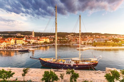 Supetar city in Brac island, Croatia. View from the sea. Picturesque scenic view on Supetar on Brac island, Croatia. Panoramic view on harbor of town Supetar from the side of sea. Brac, Croatia.