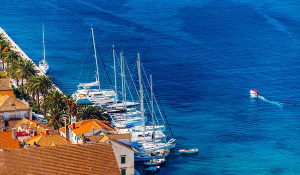 View at amazing archipelago with boats in front of town Hvar, Croatia. Harbor of old Adriatic island town Hvar. Popular touristic destination of Croatia. Amazing Hvar city on Hvar island, Croatia. 