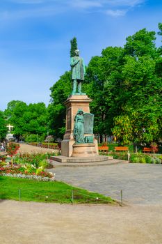 HELSINKI, FINLAND - JUNE 24, 2017: View of the Esplanade Park and the Runeberg Statue, with locals and visitors, in Helsinki, Finland