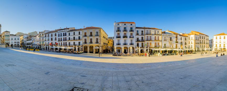 CACERES, SPAIN - DECEMBER 21, 2017: Panoramic view of the Plaza Mayor (main square), with local businesses, locals and visitors, in Caceres, Extremadura, Spain