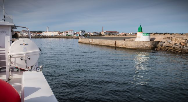 Ile d Yeu, France - September 16, 2018: View of the bridge of a ferry that enters the harbor of the island of Yeu where travelers are sitting to admire the show on a summer day