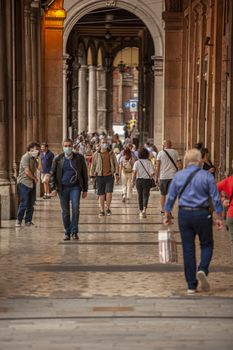 BOLOGNA, ITALY 17 JUNE 2020: People walking under arcades in Bologna, Italy