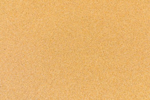 Sand surface and background. Sand Texture. Brown sand. Background from fine sand. Sand background. Closeup of sand pattern of a beach in the summer.