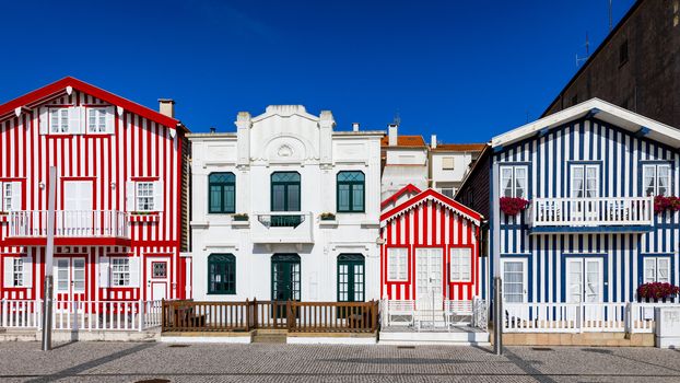 Street with colorful houses in Costa Nova, Aveiro, Portugal. Street with striped houses, Costa Nova, Aveiro, Portugal. Facades of colorful houses in Costa Nova, Aveiro, Portugal.