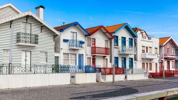 Street with colorful houses in Costa Nova, Aveiro, Portugal. Street with striped houses, Costa Nova, Aveiro, Portugal. Facades of colorful houses in Costa Nova, Aveiro, Portugal.