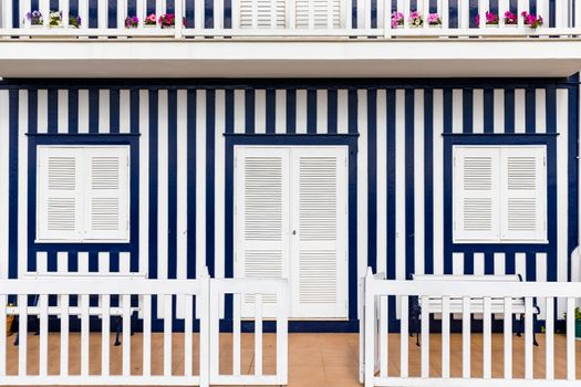 Colored Windows of "Costa Nova do Prado", Portugal. Windows in typical small wooden house with colorful stripes in Costa Nova. Aveiro. Portugal. Detail of the house in famous resort Costa Nova.