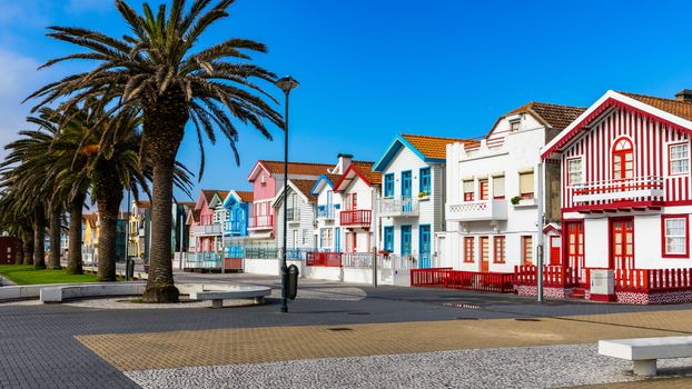 Street with colorful houses in Costa Nova, Aveiro, Portugal. Street with striped houses, Costa Nova, Aveiro, Portugal. Facades of colorful houses in Costa Nova, Aveiro, Portugal.