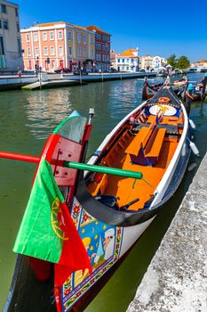 Traditional boats on the canal in Aveiro, Portugal. Colorful Moliceiro boat rides in Aveiro are popular with tourists to enjoy views of the charming canals. Aveiro, Portugal. 