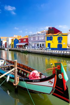 Traditional boats on the canal in Aveiro, Portugal. Colorful Moliceiro boat rides in Aveiro are popular with tourists to enjoy views of the charming canals. Aveiro, Portugal. 