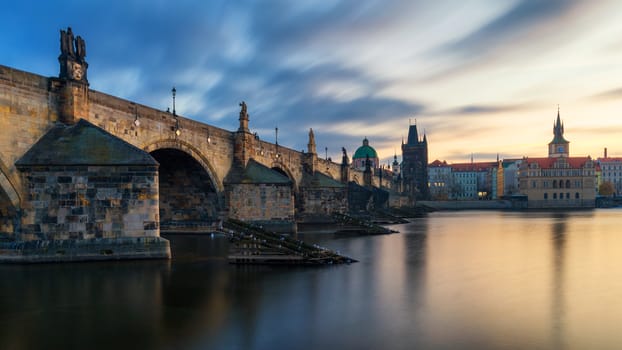 Morning view of Charles Bridge in Prague, Czech Republic. The Charles Bridge is one of the most visited sights in Prague. Architecture and landmark of Prague. Long exposure photo.