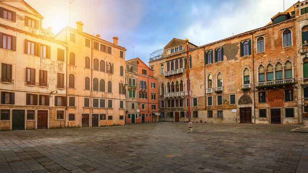 Street in Venice, Italy. Narrow street among old colorful brick houses in Venice, Italy. Venice postcard