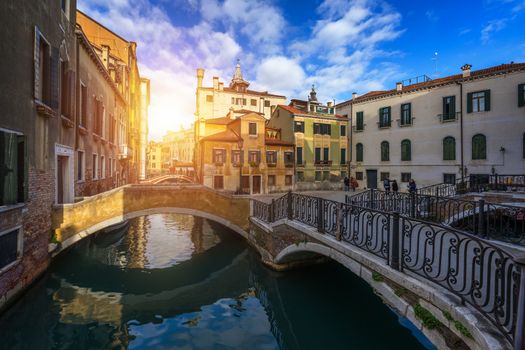 Street canal in Venice, Italy. Narrow canal among old colorful brick houses in Venice, Italy. Venice postcard