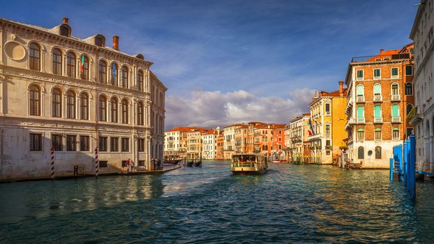 View of the street canal in Venice, Italy. Colorful facades of old Venice houses. Venice is a popular tourist destination of Europe. Venice, Italy.