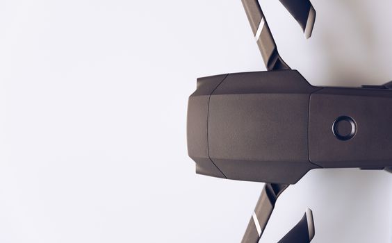 New modern drone on display on white background. Drone quadcopter with digital camera.