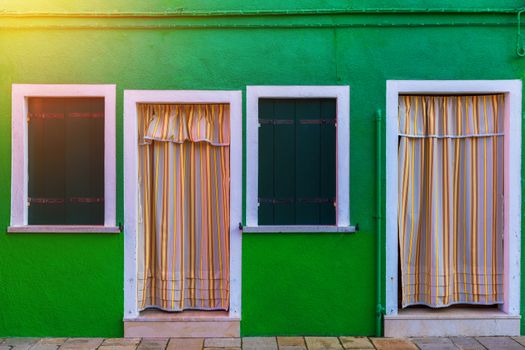 Lovely house facade and colorful walls in Burano, Venice. Burano island canal, colorful houses and boats, Venice landmark, Italy. Europe