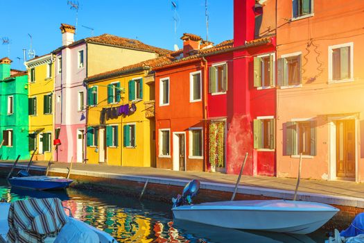 Street with colorful buildings in Burano island, Venice, Italy. Architecture and landmarks of Burano, Venice postcard. Scenic canal and colorful architecture in Burano island near Venice, Italy