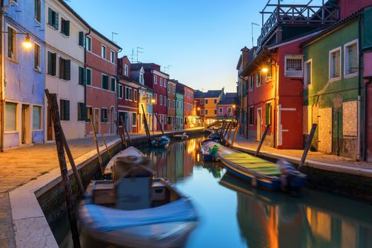 Street view with colorful buildings in Burano island at night, Venice, Italy. Architecture and landmarks of Burano, Venice postcard. Scenic canal and colorful architecture in Burano island near Venice, Italy