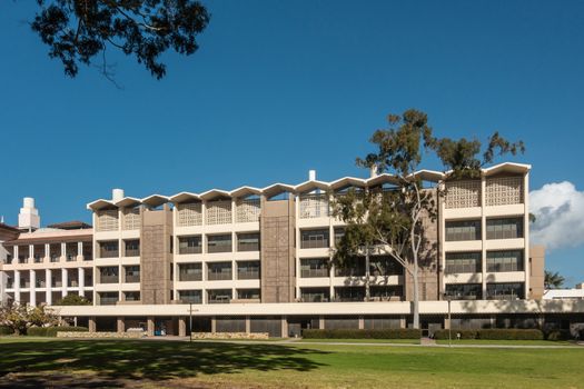 Santa Barbara, California, USA - January 6, 2019: The white and beige modern chemistry building of UCSB, behind green lawn and under blue sky.