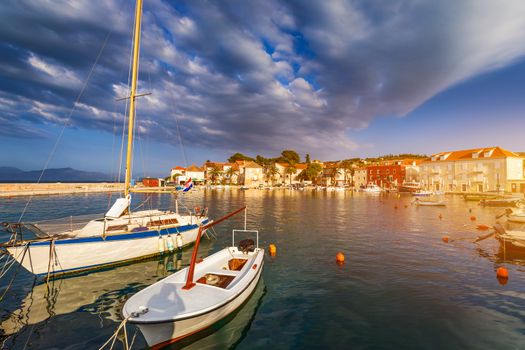 Fishing boat anchoring in beautiful Sutivan port, Brac island, Croatia. Sutivan on Island Brac in Croatia. Made of well known white limestone. Port with fishing boats. Sutivan, Brac, Croatia.