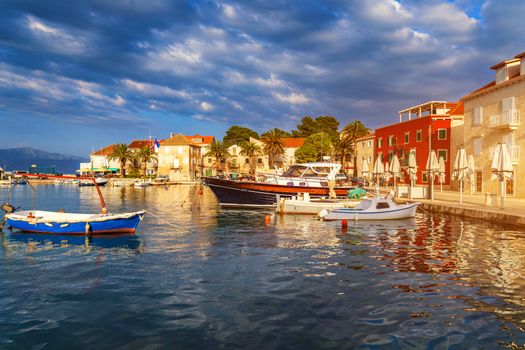 Fishing boat anchoring in beautiful Sutivan port, Brac island, Croatia. Sutivan on Island Brac in Croatia. Made of well known white limestone. Port with fishing boats. Sutivan, Brac, Croatia.