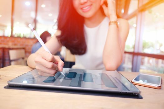 close up of a business woman analyzing business graphs on digital tablet