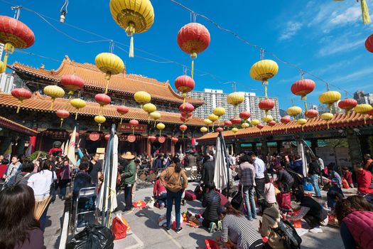 Kowloon, Hong Kong, China - JANUARY 13, 2016: people praying at Sik Sik Yuen Wong Tai Sin Temple,Wong Tai Sin also known as Huang Chu-ping