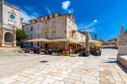 Main square in old medieval town Hvar. Hvar is one of most popular tourist destinations in Croatia in summer. Central Pjaca square of Hvar town, Dalmatia, Croatia. 