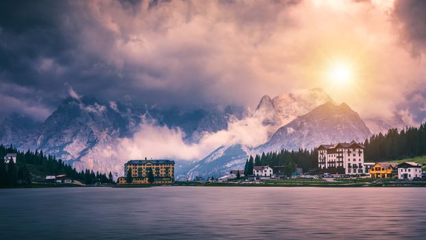 Misurina Lake in the Dolomites mountains in Italy near Auronzo di Cadore on a cloudy day, Sorapiss mountain in the background. South Tyrol, Dolomites, Italy.