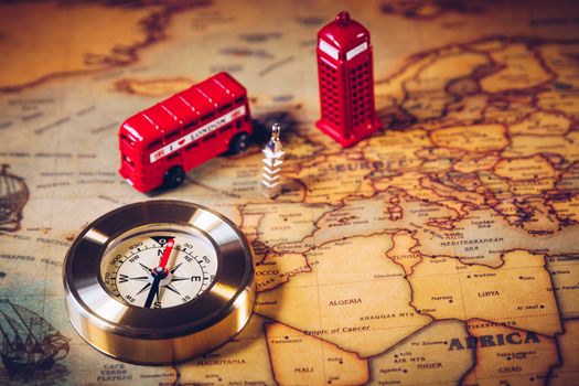 London map with Big Ben, double decker bus in miniature and compass, travel concept. England, UK.