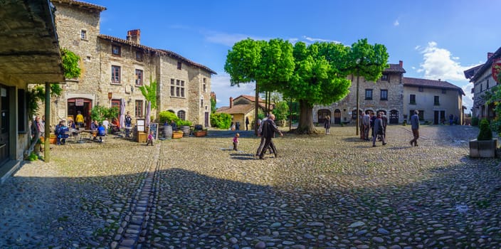 Perouges, France - May 04, 2019: Scene of the main square, with locals and visitors, in the medieval village Perouges, Ain department, France