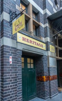 Sydney, Australia - February 12, 2019: Entance and facade to Belgian Beer Cafe Heritage in Harrington Street. Red on Yellow advertisements.