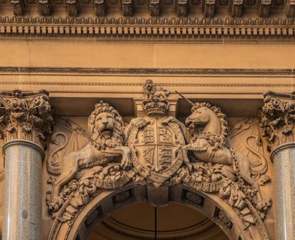 Sydney, Australia - February 12, 2019: Historic and Iconic General Post Office building facade on corner of Martin Place and , George Street. British Coat of Arms with lion and unicorn mural statue above spandrel.