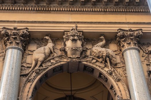 Sydney, Australia - February 12, 2019: Historic and Iconic General Post Office building facade on corner of Martin Place and , George Street. Australian Coat of Arms mural statue above spandrel.