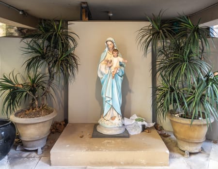 Sydney, Australia - February 12, 2019: Inside Saint Patricks Church on Grosvenor Street opposite of Lang Park. Mary and child statue on low pedestal at courtyard.