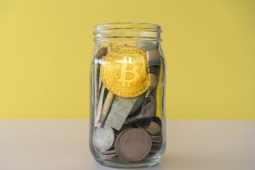 Bitcoin the jar full of coin and bank notes meaning of saving investment with cryptocurrency digital money fintech online network. Business technology concept.