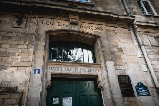 Paris, France - October 6, 2018: Facade of the Foyatier Elementary School in the middle of the Montmartre neighborhood on a fall day where it is written School of Boys - Liberty - Equality - Fraternity