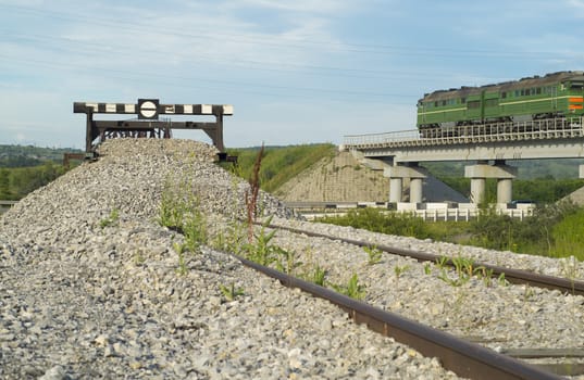 Railway impasse on the railroad tracks. View of the bridge with a railway locomotive