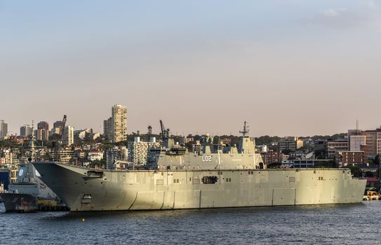 Sydney, Australia - February 12, 2019: Closeup of L02 Navy ship at Royal Australian Navy Heritage Centre with housing in back under an evening twilight sky.