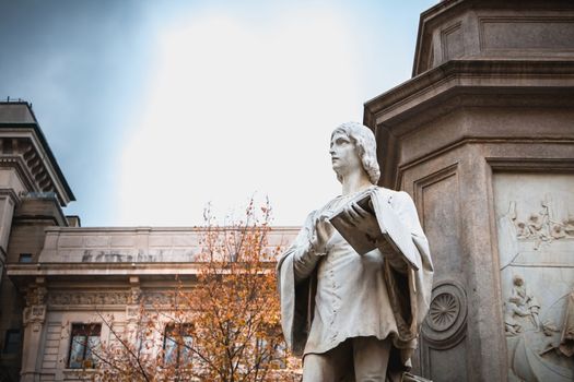 Milan, Italy - November 2, 2017: Architectural detail of a statue to the glory of Leonardo da Vinci by sculptor Pietro Magni in 1872 in front of Milan City Hall