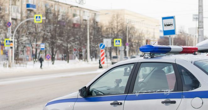 traffic police car with photo and video recording stands for observation in front of the city pedestrian crossing in the winter