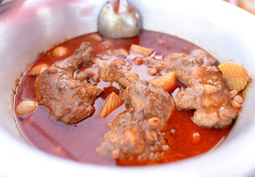 Massaman curry with chicken in a large bowl, Thai food.