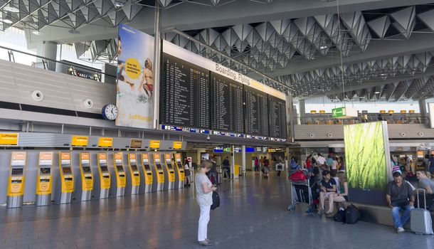 FRANKFURT AM MAIN, GERMANY - JULY 2, 2015: Travelers at public area at international Frankfurt Airport, the busiest airport in Germany. Longer exposure.

Frankfurt am Main, Germany - July 2, 2015: Travelers at public area at international Frankfurt Airport, the busiest airport in Germany. In 2012, Frankfurt handled 57.5 million passengers. Longer exposure.