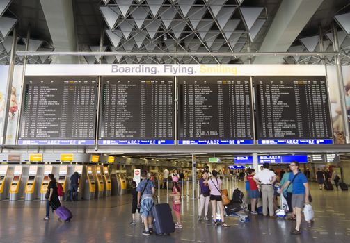 FRANKFURT AM MAIN, GERMANY - JULY 2, 2015: Travelers at public area at international Frankfurt Airport, the busiest airport in Germany. Longer exposure.

Frankfurt am Main, Germany - July 2, 2015: Travelers at public area at international Frankfurt Airport, the busiest airport in Germany. In 2012, Frankfurt handled 57.5 million passengers. Longer exposure.